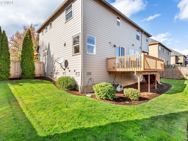 back of property with a lawn and a wooden deck