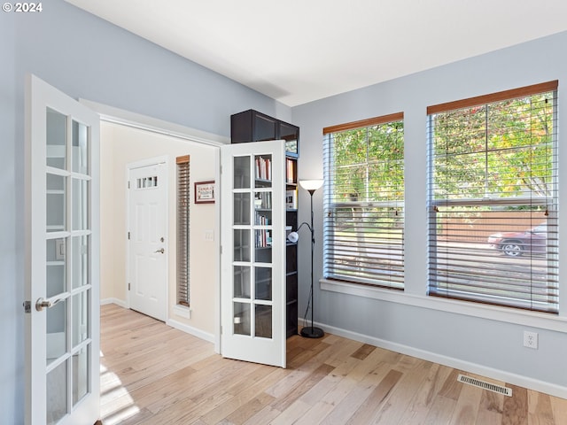 interior space featuring french doors and light hardwood / wood-style flooring