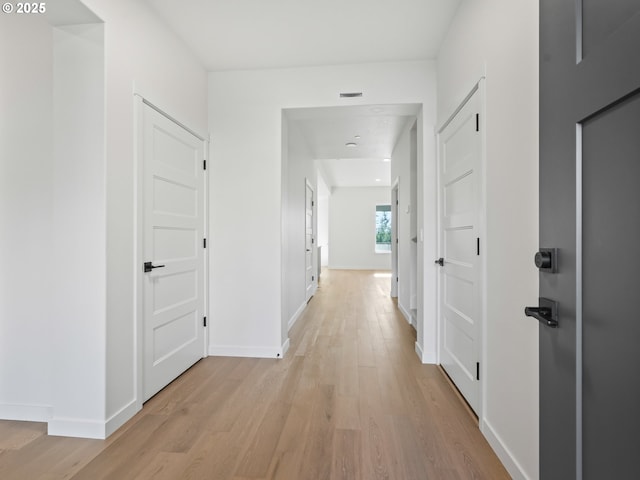 hall with light hardwood / wood-style floors