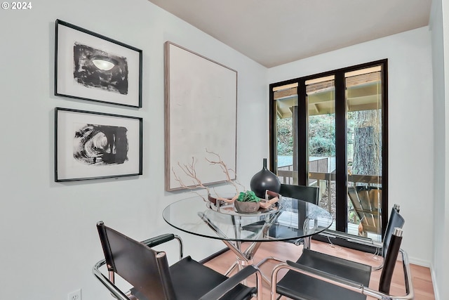 dining space with wood-type flooring