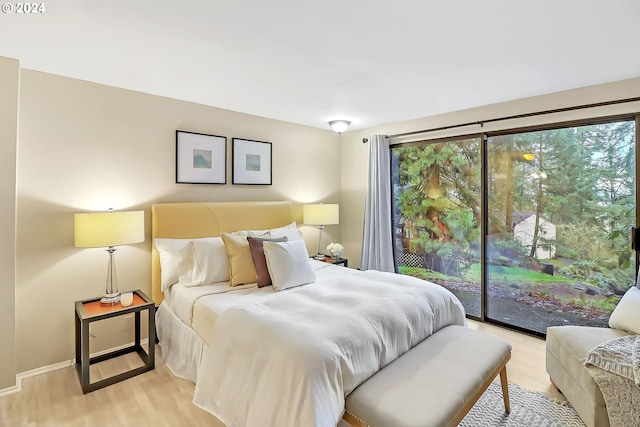 bedroom featuring access to exterior and light hardwood / wood-style flooring