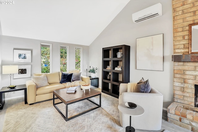 living room with an AC wall unit, light hardwood / wood-style flooring, lofted ceiling, and a brick fireplace