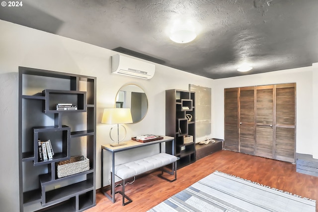 interior space featuring a wall mounted AC and hardwood / wood-style flooring