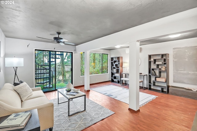 living room featuring hardwood / wood-style flooring and ceiling fan