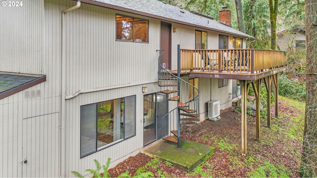 rear view of house featuring central air condition unit and a wooden deck