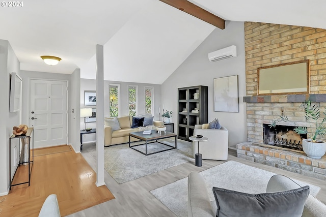 living room with vaulted ceiling with beams, a fireplace, a wall mounted air conditioner, and light wood-type flooring