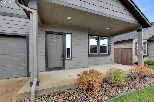 doorway to property with a garage