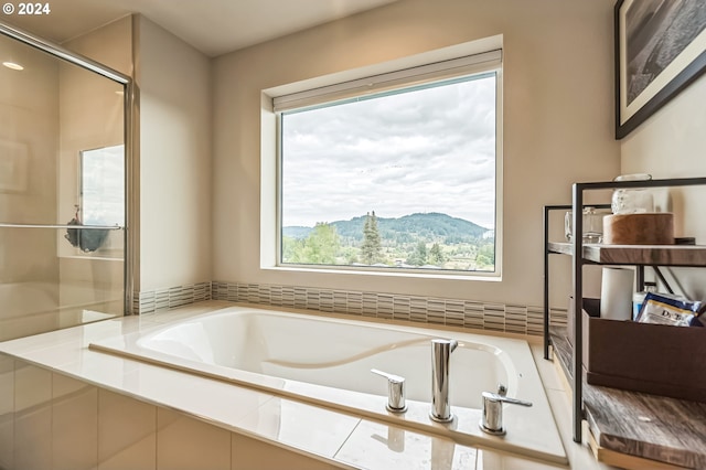 bathroom featuring a mountain view and shower with separate bathtub