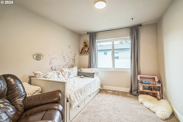 carpeted bedroom with a textured ceiling