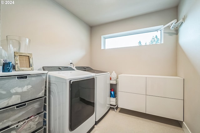 clothes washing area featuring washer and dryer