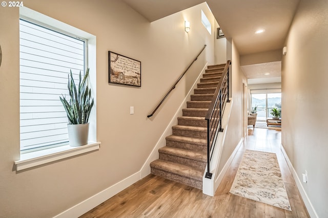 stairway featuring wood-type flooring