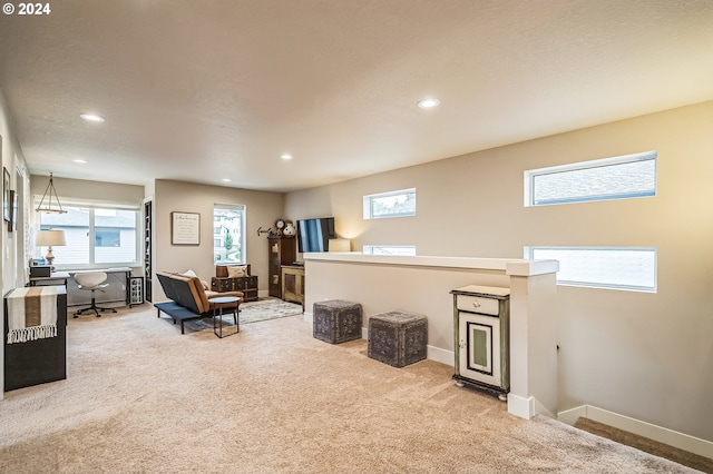 living room featuring carpet flooring and a textured ceiling