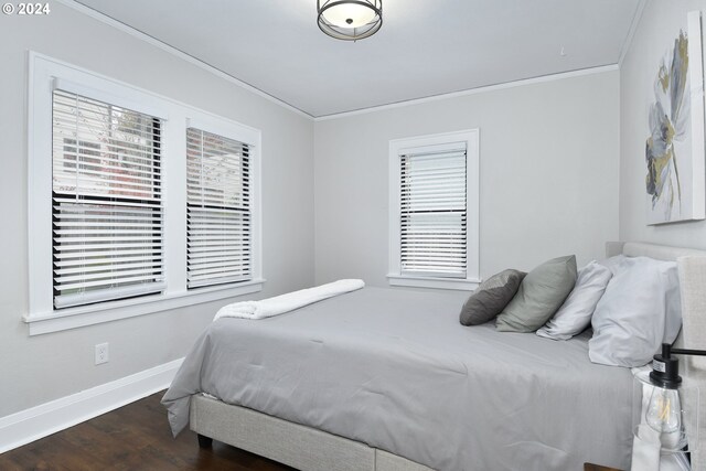 bedroom featuring dark hardwood / wood-style flooring and crown molding