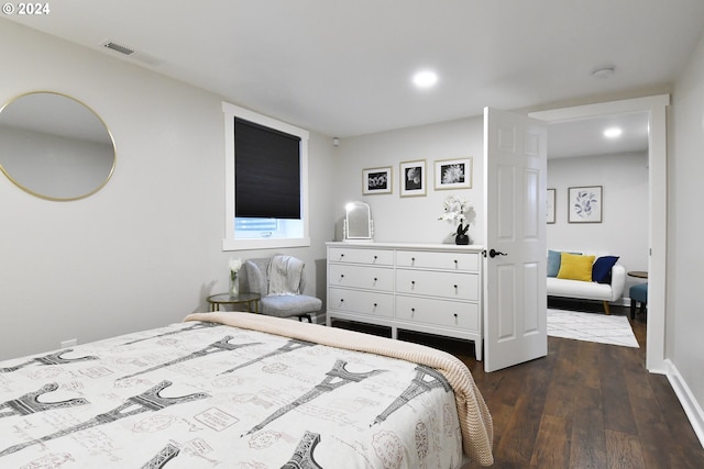 bedroom with dark wood-type flooring