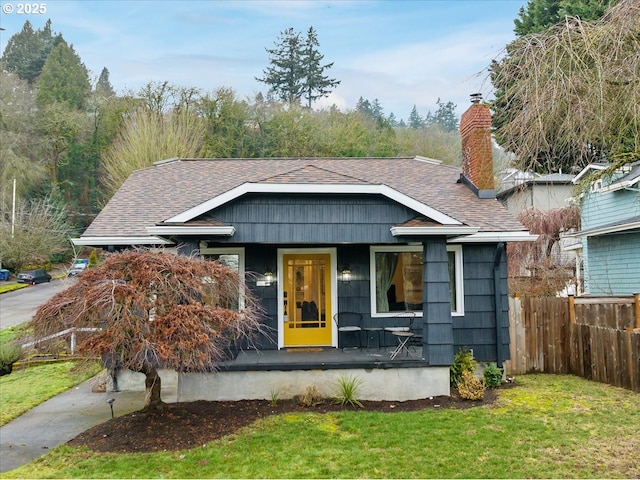 view of front of home with a front yard and covered porch