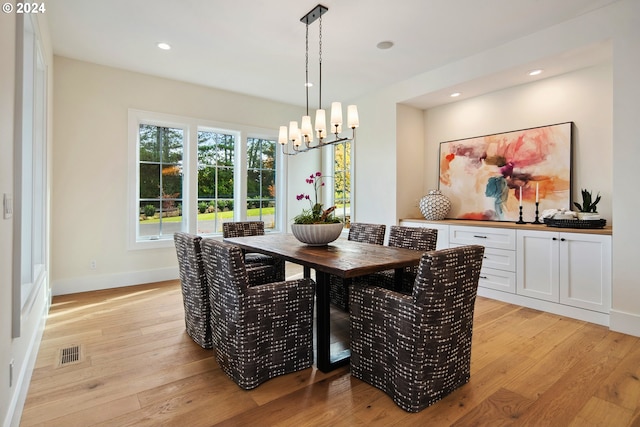 dining room featuring an inviting chandelier and light hardwood / wood-style floors