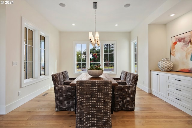 dining space featuring a notable chandelier and light hardwood / wood-style flooring