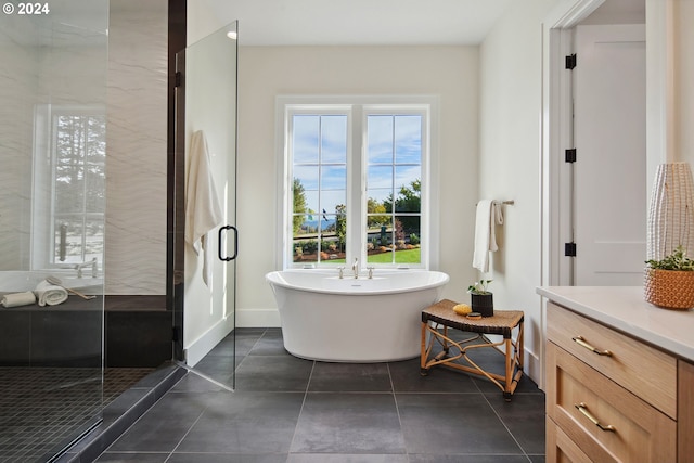 bathroom with tile patterned floors, shower with separate bathtub, and vanity