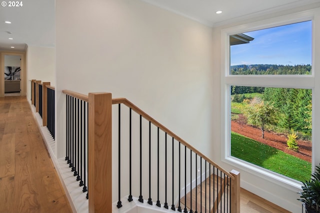 stairs with crown molding and hardwood / wood-style floors