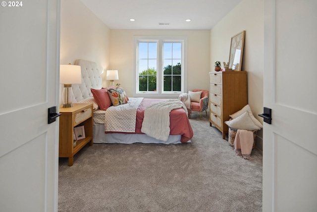 bedroom featuring light carpet