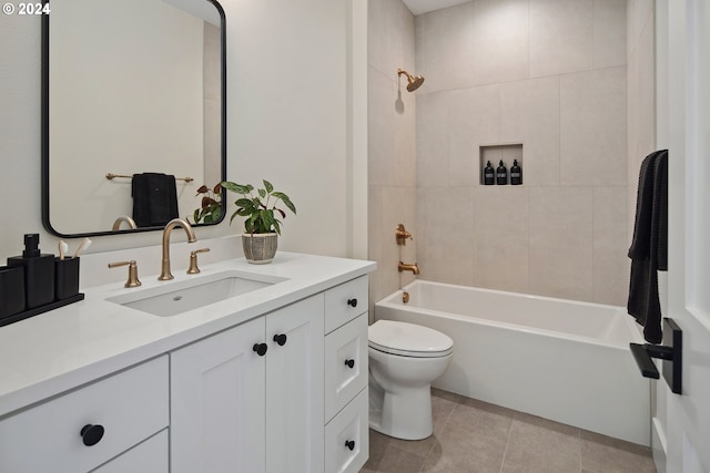 full bathroom featuring tiled shower / bath, vanity, toilet, and tile patterned flooring