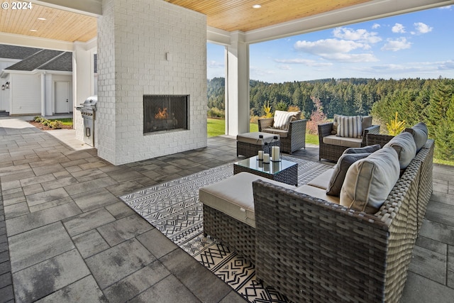 view of patio / terrace featuring grilling area and an outdoor living space with a fireplace