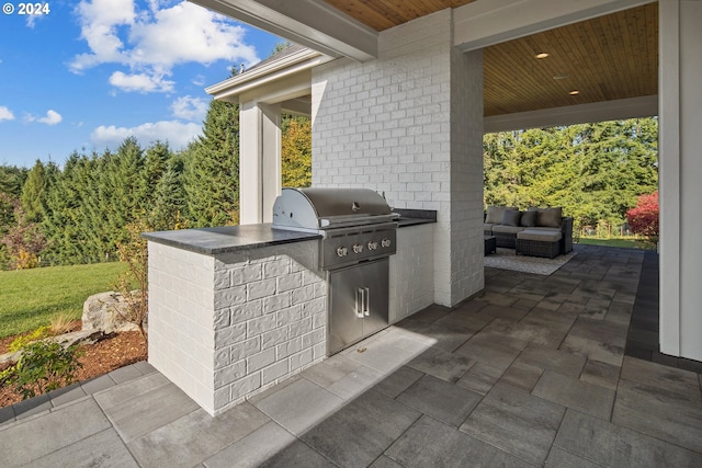 view of patio / terrace featuring an outdoor living space, grilling area, and exterior kitchen