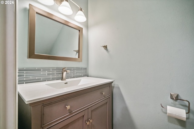 bathroom with vanity and tasteful backsplash