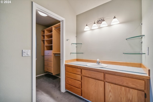 bathroom with vanity and vaulted ceiling