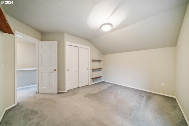 bonus room with carpet floors and vaulted ceiling