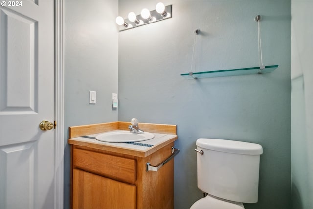 bathroom featuring toilet and vanity