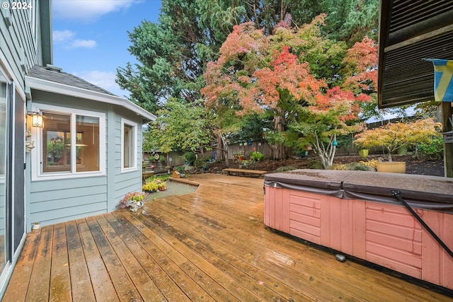 wooden terrace featuring a hot tub