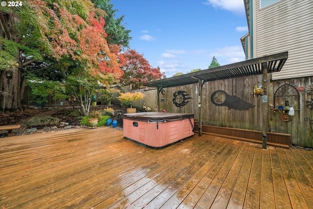 wooden terrace featuring a hot tub