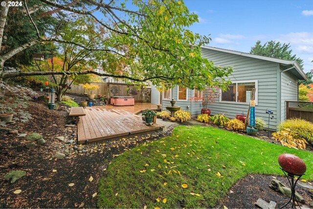 view of yard with a hot tub and a deck