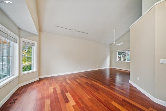 spare room with high vaulted ceiling, hardwood / wood-style flooring, and ceiling fan