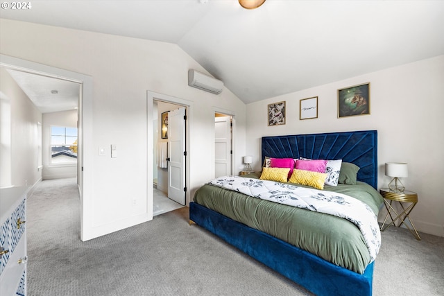 carpeted bedroom with lofted ceiling, connected bathroom, and a wall mounted air conditioner