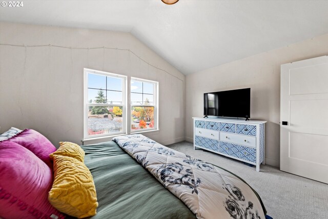 carpeted bedroom featuring vaulted ceiling