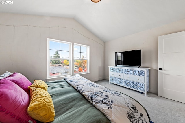 carpeted bedroom featuring vaulted ceiling