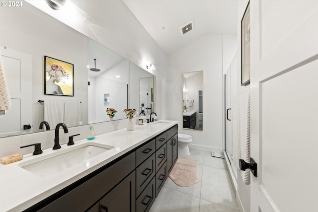 bathroom featuring lofted ceiling, toilet, double sink vanity, tile patterned floors, and walk in shower