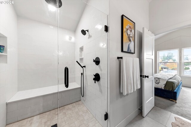 bathroom with walk in shower and tile patterned flooring