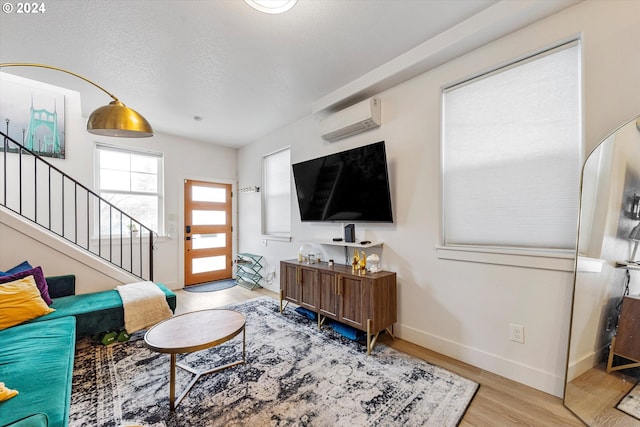 living room featuring light wood-type flooring and a wall mounted AC