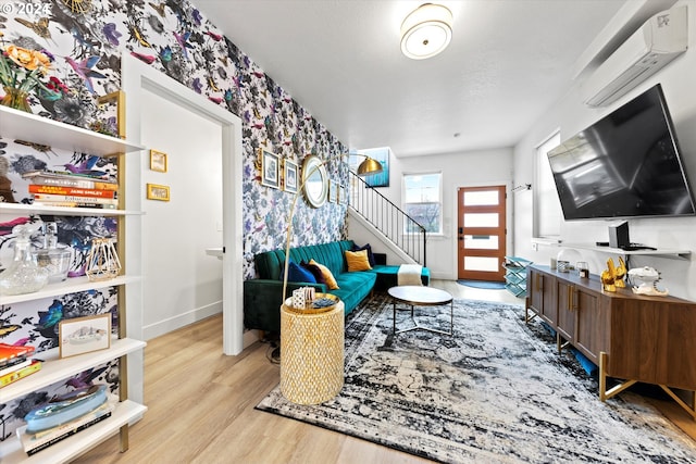 interior space featuring an AC wall unit and light hardwood / wood-style floors