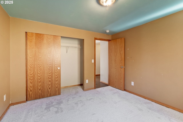 unfurnished bedroom featuring a closet and carpet flooring