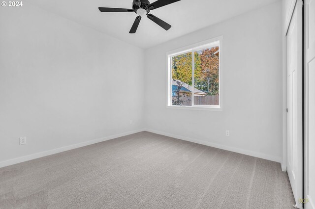 unfurnished bedroom featuring a closet, carpet, and ceiling fan