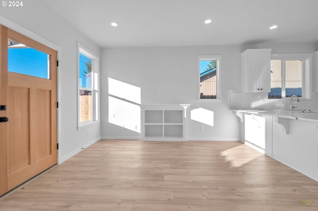 entryway with sink and light hardwood / wood-style floors