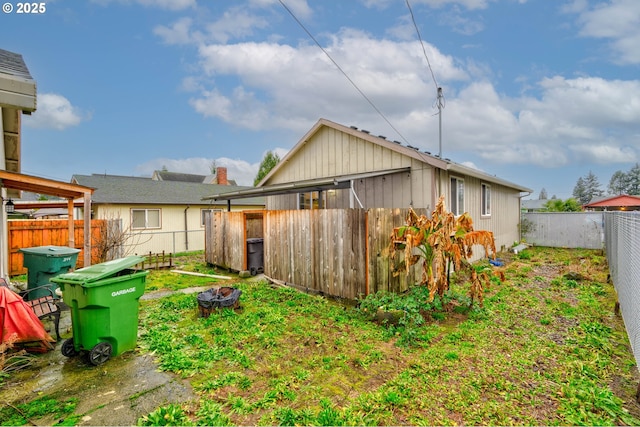 back of property with an outdoor fire pit