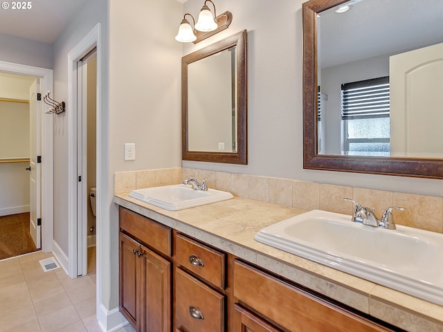 bathroom featuring vanity, tile patterned floors, and toilet