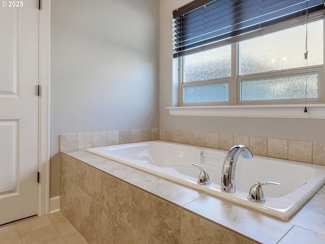 bathroom with tile patterned flooring and tiled bath