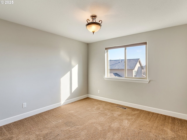 unfurnished room with carpet floors