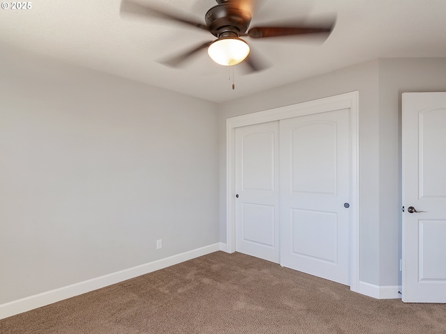 unfurnished bedroom featuring carpet, ceiling fan, and a closet